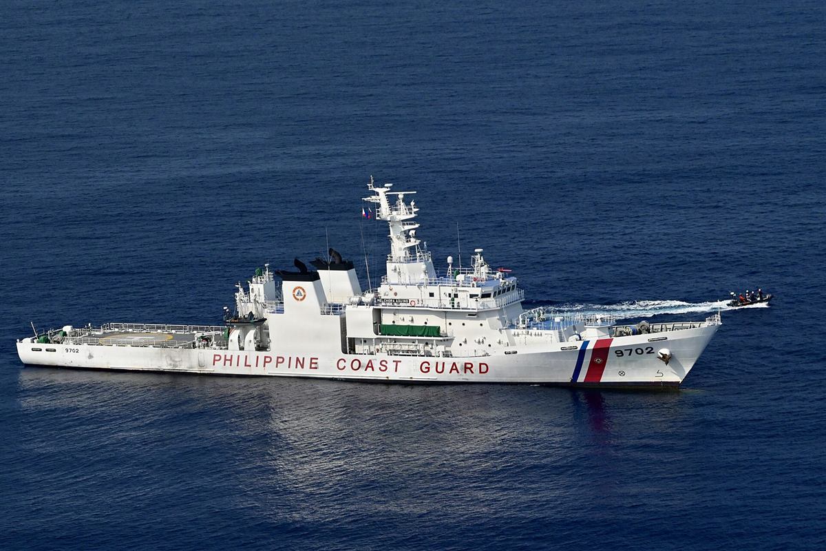 BRP Melchora Aquino launching a small boat to recover a training dummy during a search and rescue exercise.